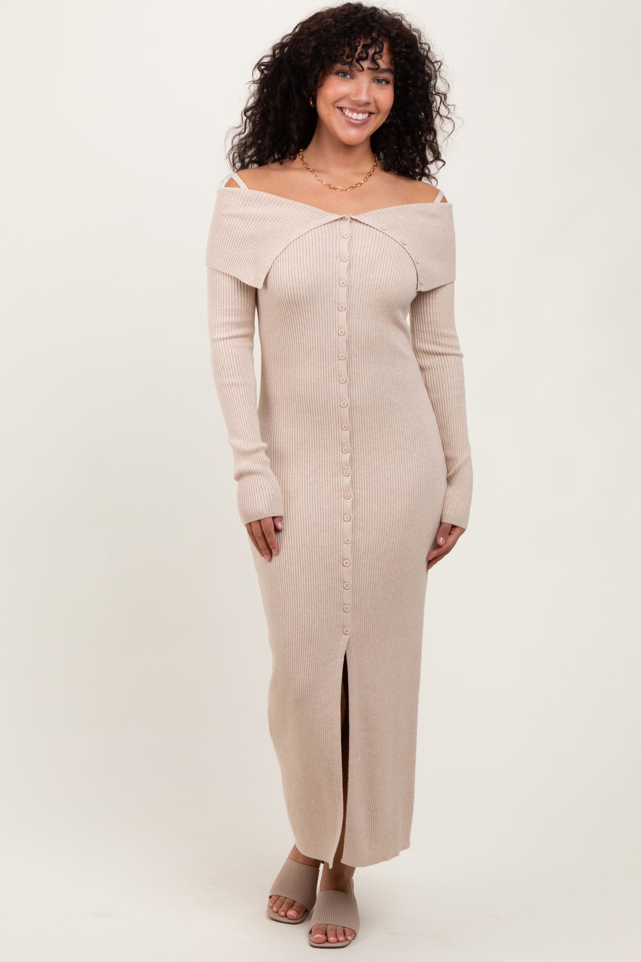 woman wearing a beige ribbed off-the-shoulder maxi dress with button-down front and side slit