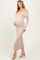 woman wearing a light beige off-the-shoulder maternity dress with buttons and a fitted silhouette, cradling her baby bump