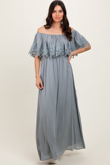 woman wearing a light blue off-the-shoulder maxi dress with lace detailing on the sleeves