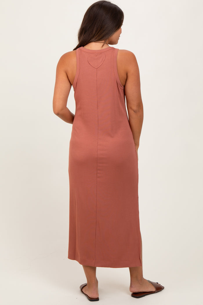 woman wearing a rust-colored ribbed maternity maxi dress viewed from the back