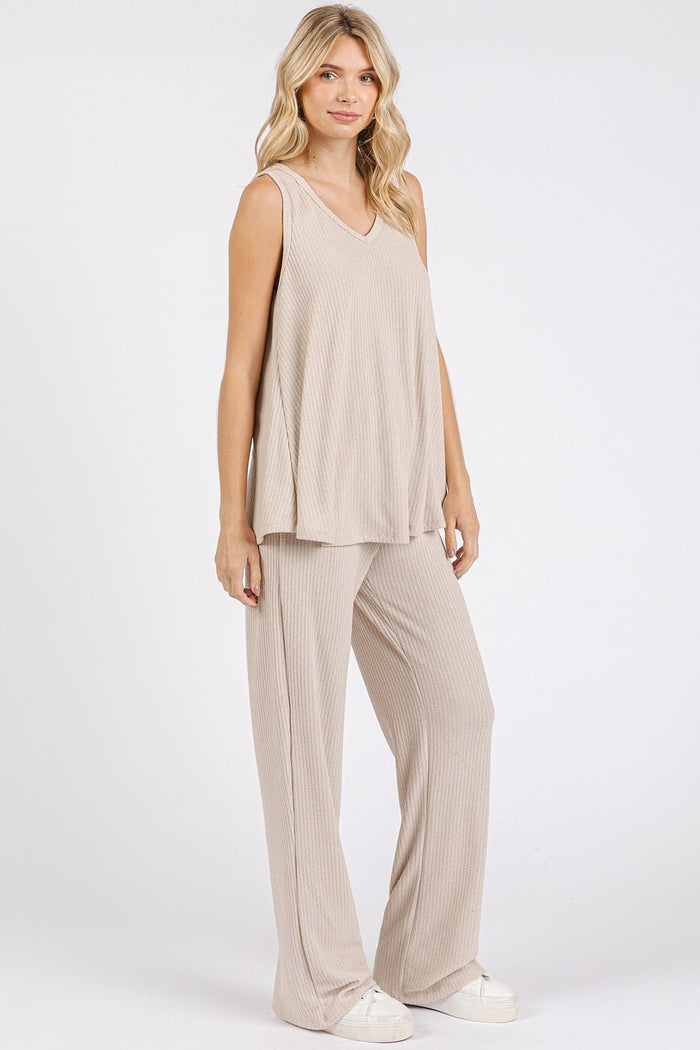 woman wearing a beige ribbed lounge set with a sleeveless top and wide-leg pants