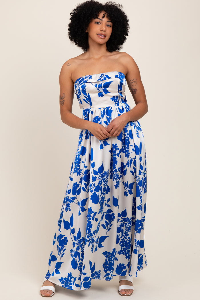 woman wearing a strapless maxi dress with a blue floral print on a white background