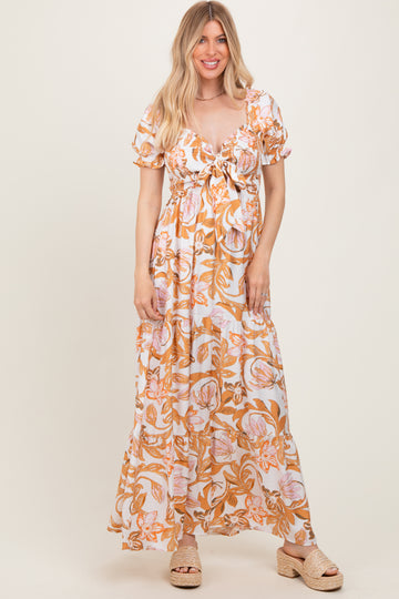 woman wearing a floral maxi dress with puff sleeves and a tie front detail