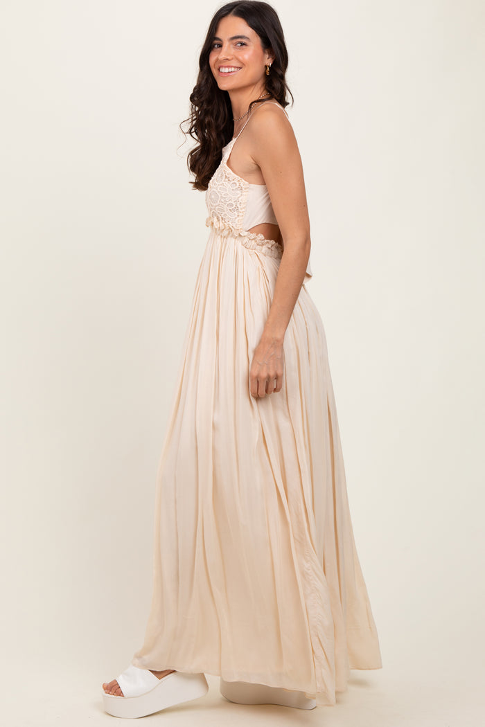 woman wearing a beige maxi dress with floral embroidery, side view, and styled with white platform sandals