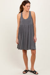 woman wearing a gray ribbed tank dress with a flared skirt and sandals