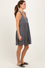 woman wearing a gray striped sleeveless dress with a relaxed fit and a flared silhouette