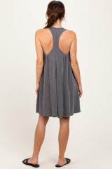 woman wearing a gray stripe sleeveless dress with a fitted bodice and flared skirt, showing an open back design