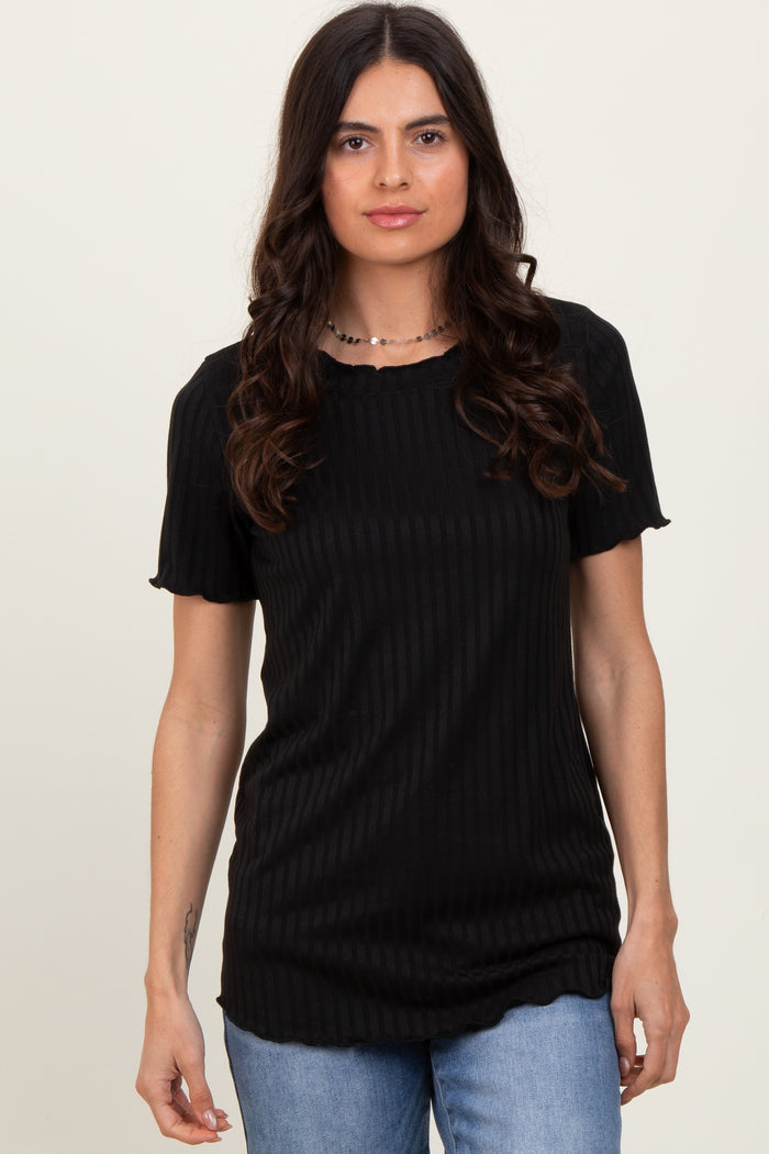 woman wearing a black ribbed short sleeve top with a scalloped neckline and relaxed fit