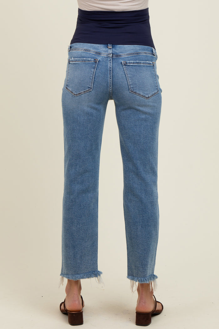woman wearing light blue maternity jeans with a frayed hem, seen from the back