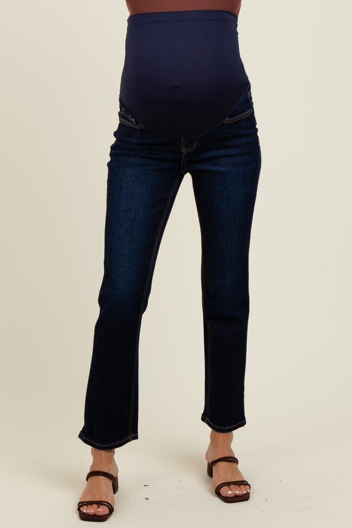 woman wearing dark blue maternity jeans with a high waistband and slight flare, showcasing a pregnant belly
