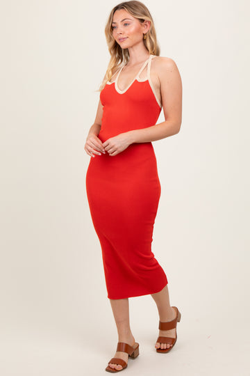 woman wearing a red ribbed midi dress with white straps and brown heeled sandals