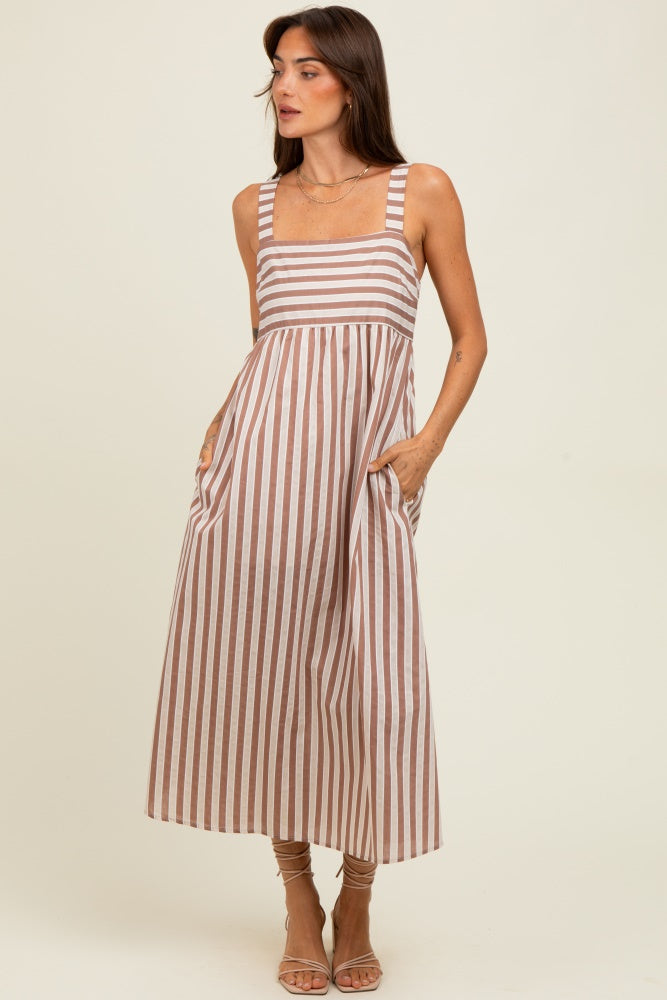 woman wearing a brown and white striped maxi dress with pockets and wide straps