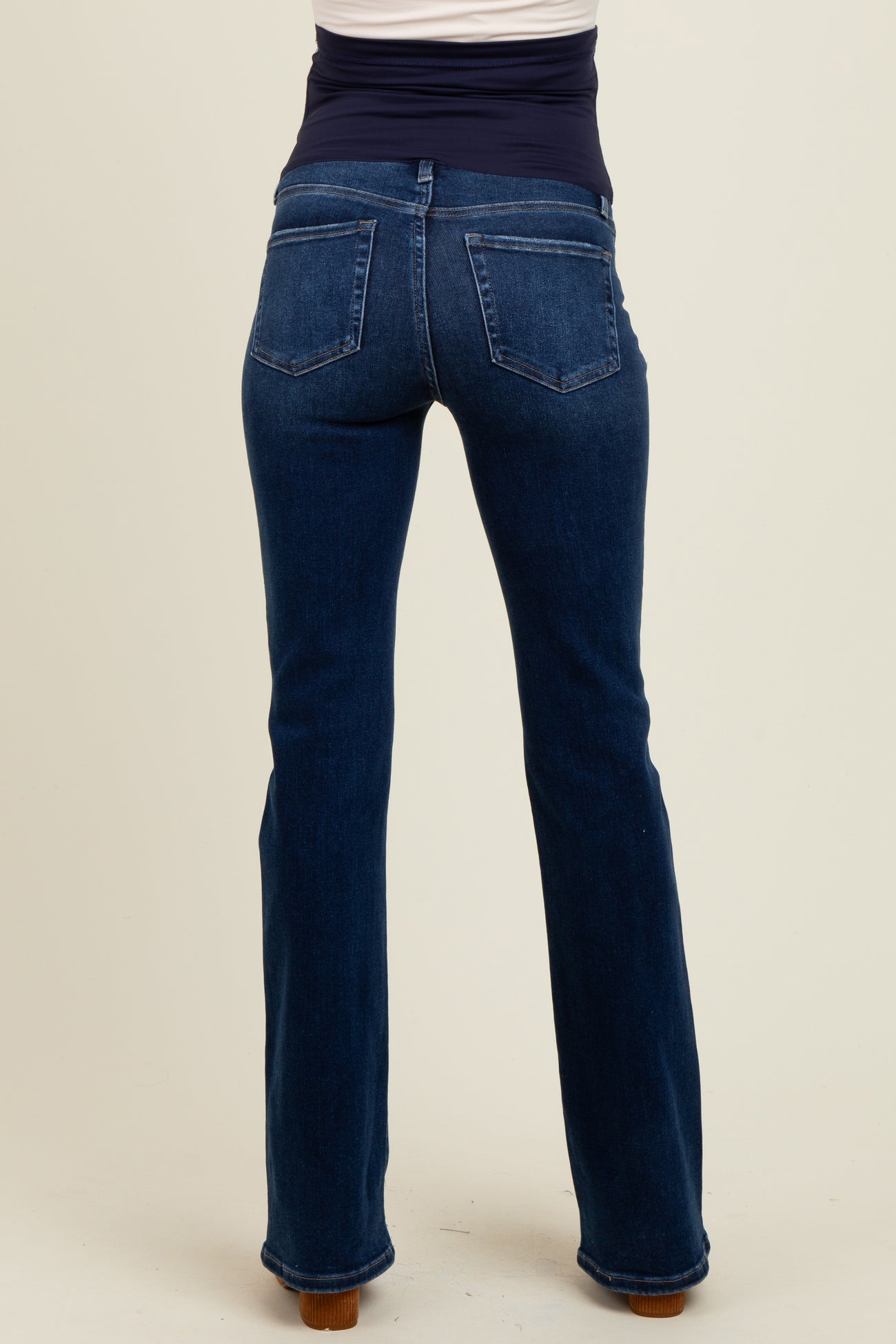 maternity wear dark blue bootcut jeans with a stretchy waistband, no visible baby bump