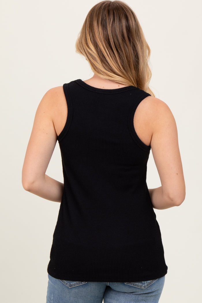 woman wearing a black ribbed tank top seen from the back with long hair and casual denim jeans