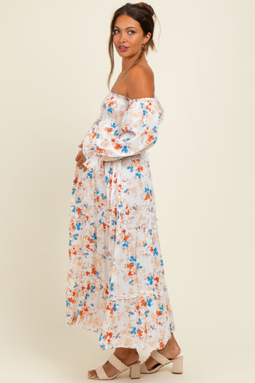 woman wearing a floral off-the-shoulder maternity dress with puff sleeves and a visible baby bump