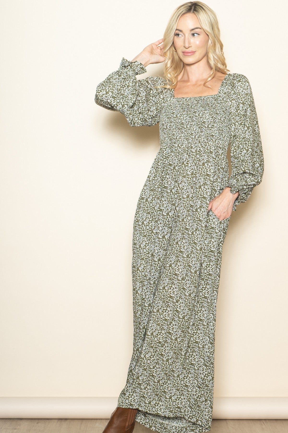 woman wearing a long floral maxi dress with square neckline and puffed sleeves