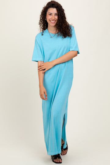 woman wearing a light blue short sleeve maxi dress with side slits and a relaxed fit