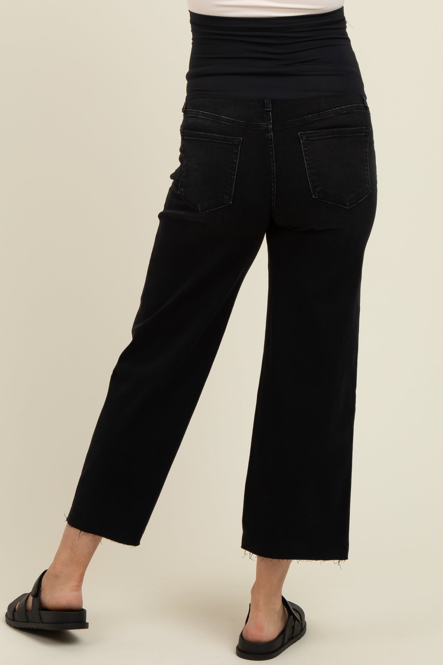 woman wearing black maternity wide leg jeans with a high waistband, viewed from the back
