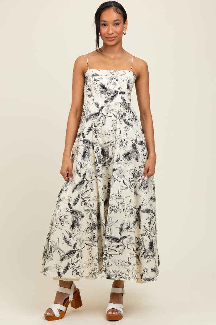 woman wearing a floral print maxi dress with spaghetti straps and a flowy silhouette