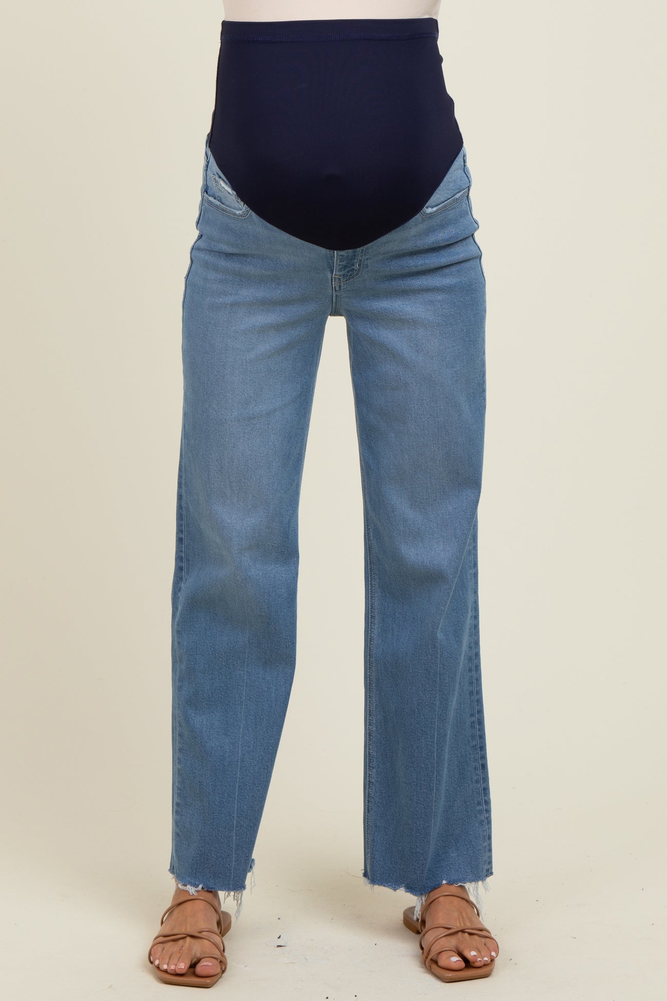 maternity wear blue distressed wide leg jeans with a navy belly band, featuring frayed hem and model wearing them