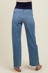 woman wearing light blue maternity wide-leg jeans, showing the back and hem detailing