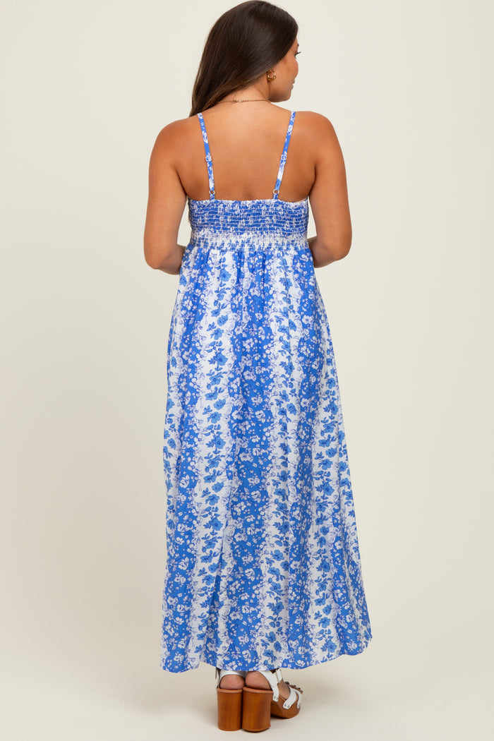 woman wearing a blue floral maternity maxi dress with a smocked back and thin straps, showing her back