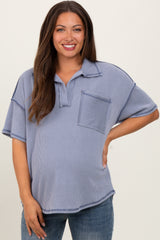 woman wearing a striped blue maternity polo shirt with a front pocket and a visible baby bump