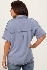 woman wearing a relaxed fit blue striped maternity top, showing a back view and casual style