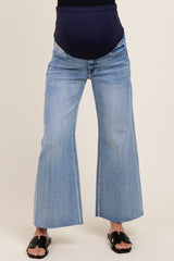 woman wearing light blue maternity flared jeans with a dark blue over-the-bump waistband