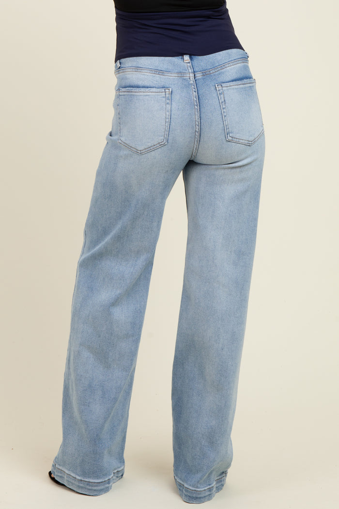 woman wearing light blue wide-leg maternity jeans, showcasing the back view