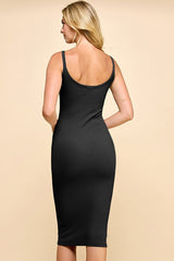 woman wearing a black ribbed midi dress with a fitted silhouette and thin straps, shown from the back