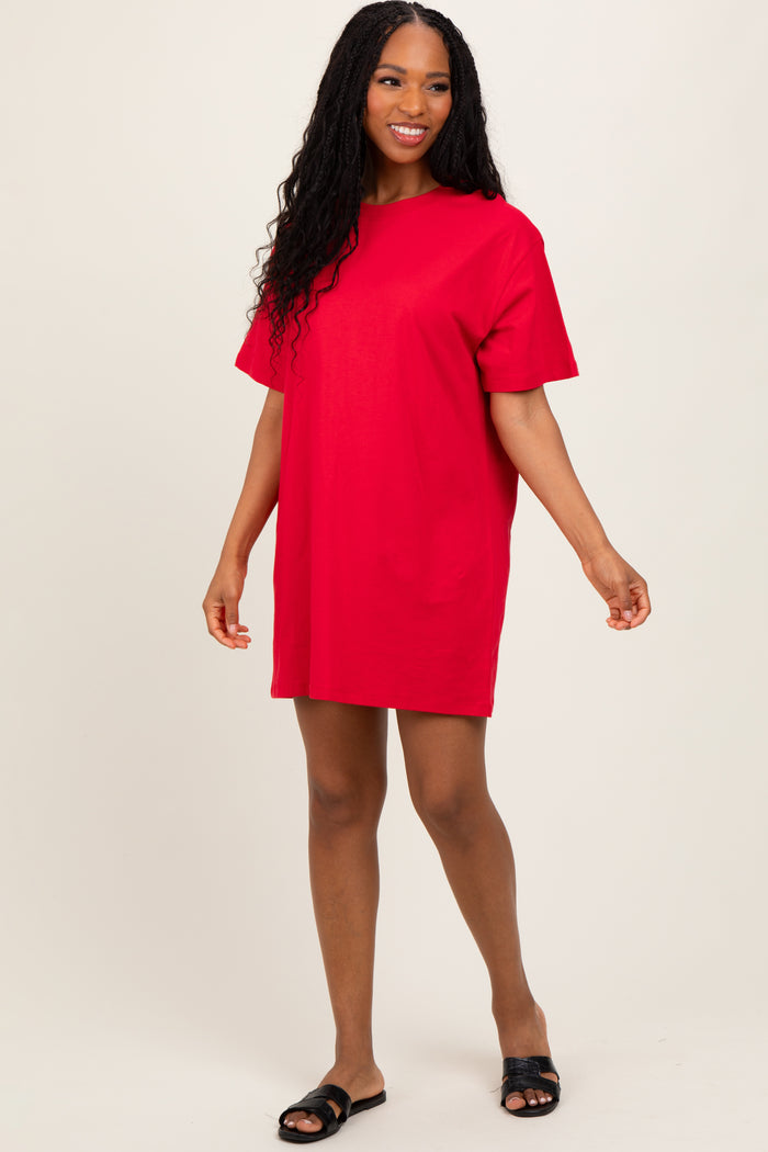 woman wearing a vibrant red short sleeve t-shirt dress with a relaxed fit and black slide sandals