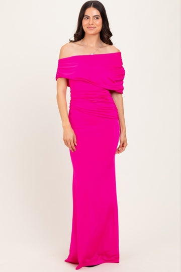 woman wearing a bright pink off-the-shoulder long dress with ruched details and a fitted silhouette