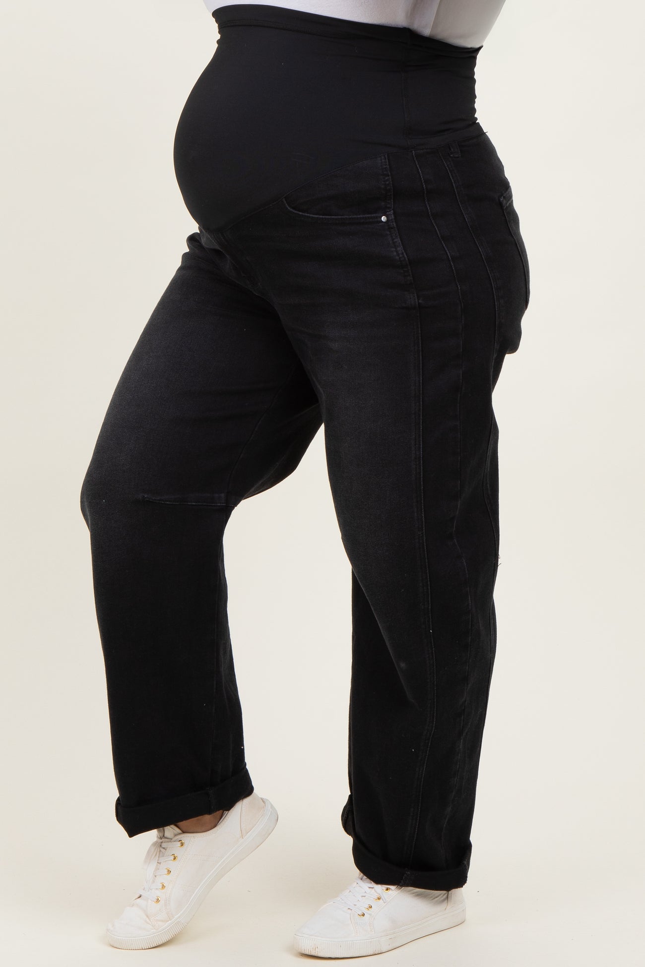 woman wearing black maternity plus jeans with a stretchy waistband, showcasing a visible baby bump