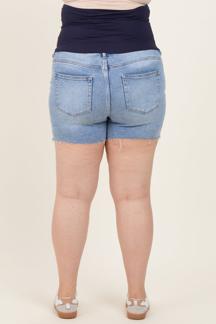 woman wearing light wash maternity plus denim shorts, showing a mid-rise and frayed hem, with a smooth waistband stye