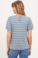 woman wearing a blue striped maternity top with puff sleeves and a keyhole back detail
