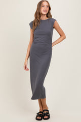 woman wearing a gray sleeveless midi dress with a straight silhouette and side slit
