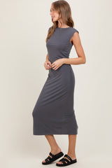 woman wearing a dark gray cap sleeve midi dress and black slide sandals