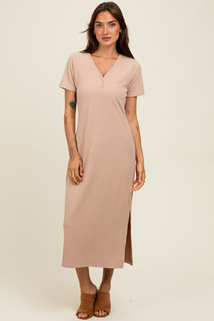 woman wearing a short sleeve beige ribbed maxi dress with a v-neck and side slit