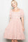 woman wearing a pink and white checkered puff sleeve dress with a smocked bodice and ruffle hem