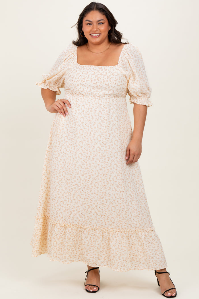 woman wearing a cream floral maxi dress with puff sleeves and a square neckline, styled with strappy black heels