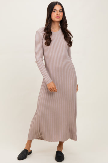woman wearing a light taupe long sleeve ribbed maxi dress and black slip-on shoes