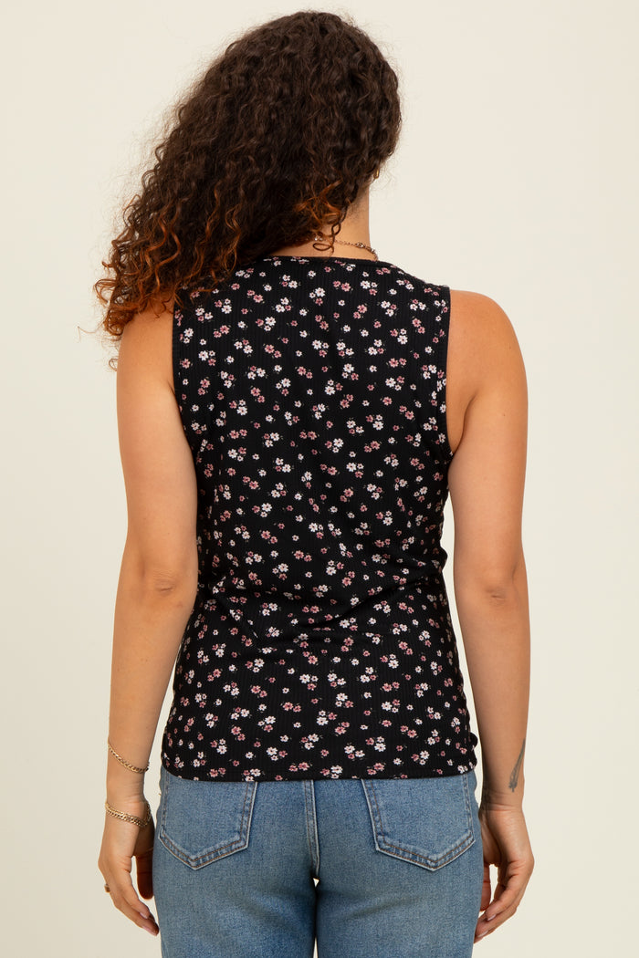 woman wearing a black floral maternity tank top with a fitted silhouette and showing her back