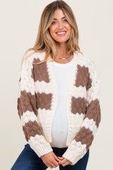 woman wearing a cream and brown patterned maternity cardigan, showcasing her baby bump
