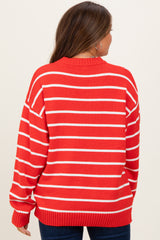 woman wearing a red and white striped maternity sweater, viewed from the back