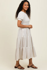 woman wearing a beige striped tiered maxi dress with short sleeves and a relaxed fit