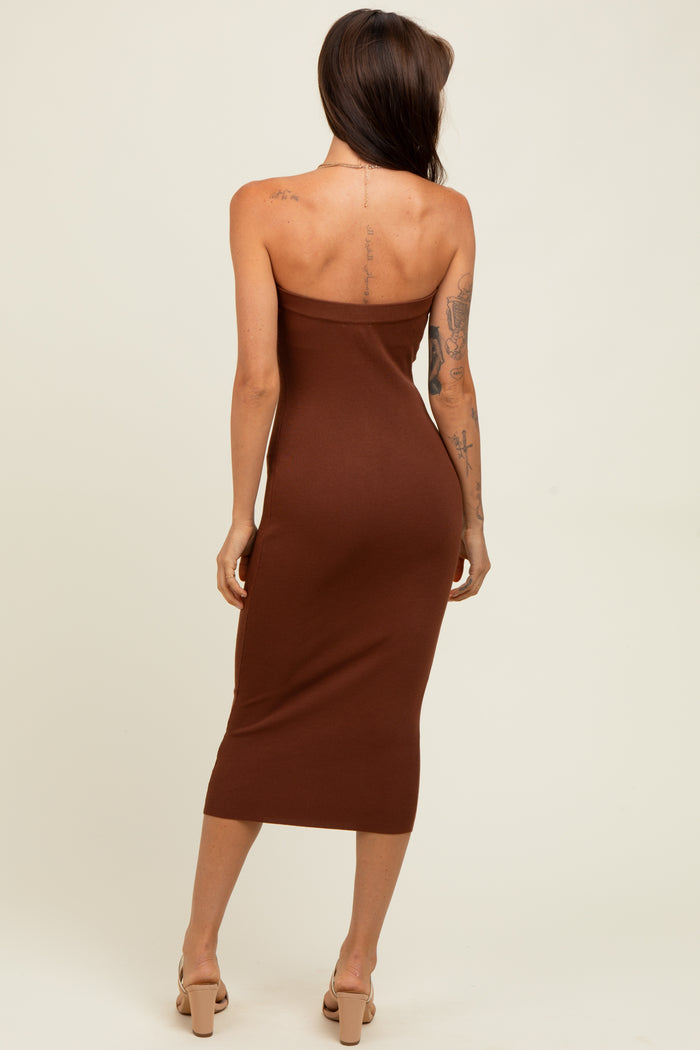 woman wearing a chocolate brown strapless midi dress, standing with her back to the camera