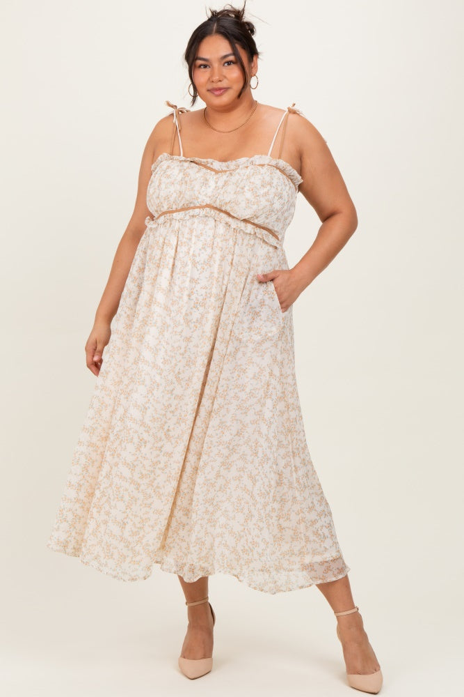 woman wearing a floral plus-size maxi dress with adjustable straps and pockets