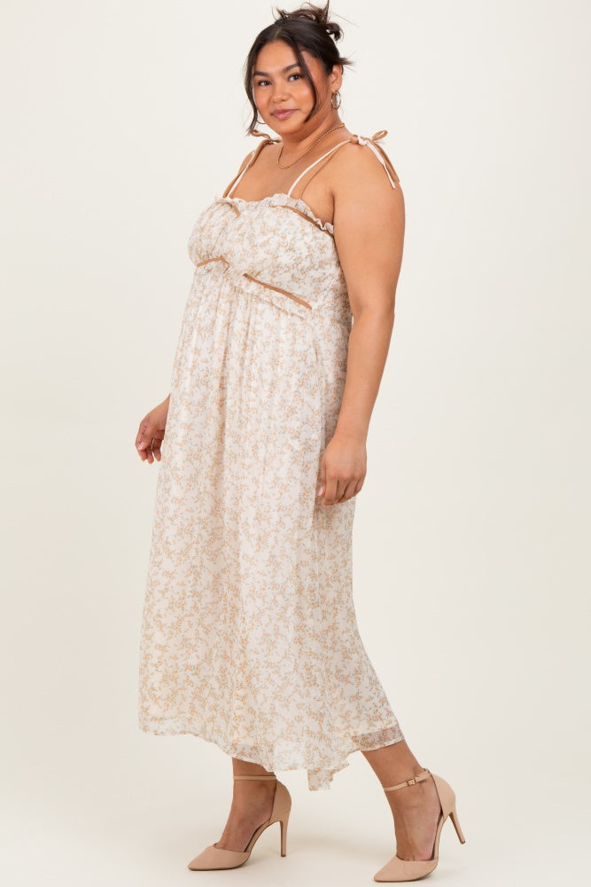 woman wearing a floral print plus size maxi dress with adjustable straps and a bow detail, paired with nude heels