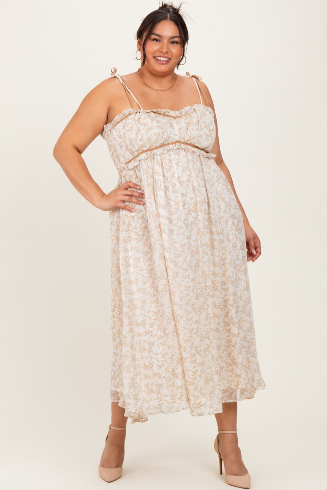 woman wearing a light beige floral plus size maxi dress with thin straps and a fitted bodice